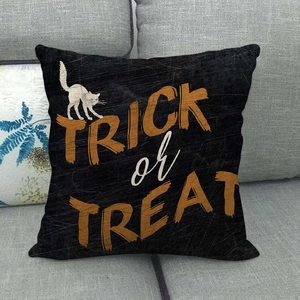 Halloween black pillow cover with cat silhouette and Trick or Treat text on grey sofa