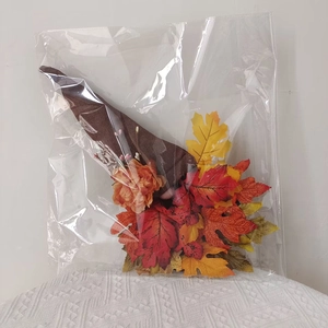 Close-up of fall harvest gnome with rustic burlap hat and colorful maple leaf details