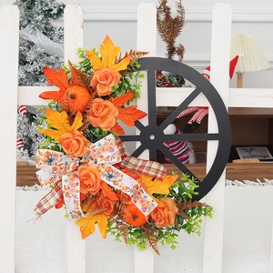 Autumn wreath with pumpkin and wheel on white fence for Thanksgiving decor