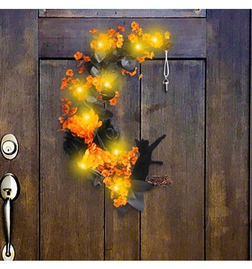 Detail of crescent moon Halloween wreath with black cat silhouette and LED lights