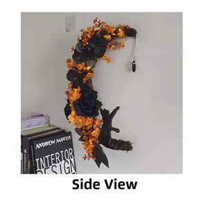Detail view of Halloween crescent moon wreath with black roses and warm LED lights