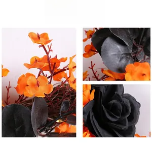 Detailed close-up of orange silk flowers and black roses on a Halloween cat wreath