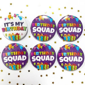 Close-up of It's My Birthday and Birthday Squad tinplate badges with party decorations