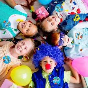 Kids wearing birthday squad and its my birthday badges during a colorful party celebration