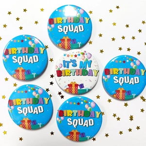 Detailed top view of 6-piece birthday badge set with squad themes and colorful party elements