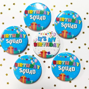 Detailed view of 58mm tinplate birthday badges with balloons and gift patterns