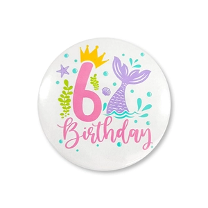 Detailed view of mermaid-themed birthday tin badge featuring pink number 6 and sea elements