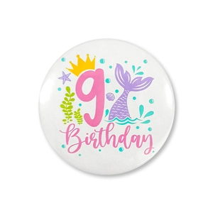 Detail of mermaid theme 9th birthday badge with pink number nine and crown for party decoration