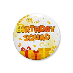 Detail of white tinplate Birthday Squad badge featuring gift boxes and butterfly prints