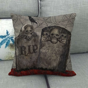 Linen Halloween skull cushion cover with tombstone and raven print on a sofa