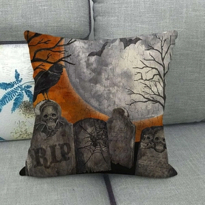 Detail of linen cushion cover featuring a gothic cemetery scene with skulls and crows
