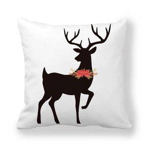 Detail of Christmas reindeer silhouette with festive wreath on soft white pillowcase