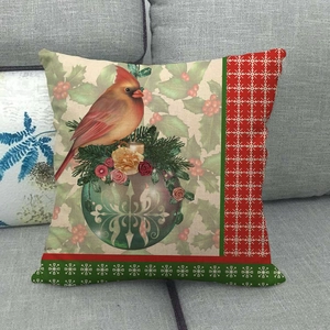 Detail of Christmas cardinal and snowflake pattern on linen cushion cover for sofa