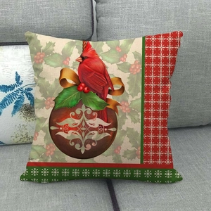 Close-up of linen Christmas pillow cover with cardinal bird and holly berry patterns