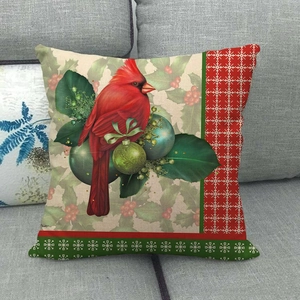 Linen Christmas cardinal throw pillow cover with winter holly and berries on gray sofa