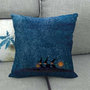 Detail of linen Halloween cushion cover with starry sky and witches on grey sofa