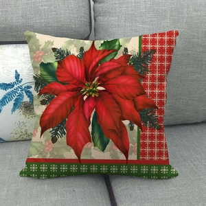 Detailed close-up of a Christmas poinsettia print on a textured linen pillowcase on a sofa