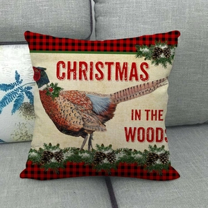 Detail of Christmas pillow with red buffalo plaid border and pheasant print on sofa