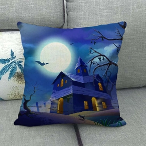 Blue starry night Halloween linen pillow cover with castle and bat print on a grey sofa