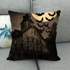 Close-up of Halloween linen pillowcase featuring a haunted house, bats, and a full moon