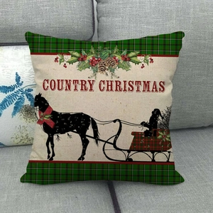 Detail of Country Christmas linen pillowcase with vintage carriage on a grey sofa