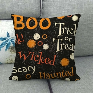 Detail of Halloween throw pillow cover with BOO print on a grey fabric sofa