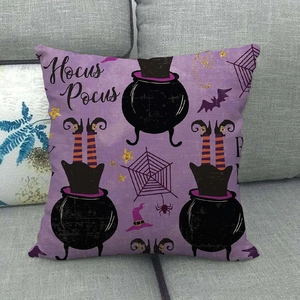 Detail of purple Halloween pillowcase featuring Hocus Pocus text and witch cauldron on sofa
