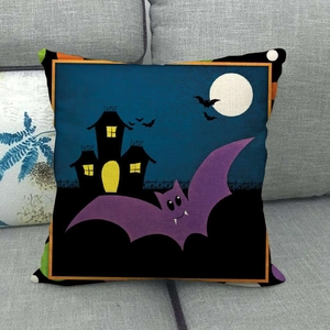 Halloween pillow cover featuring cartoon bats and castle on a grey sofa