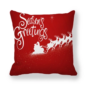 Detail of red Christmas pillowcase with Season's Greetings text and Santa silhouette