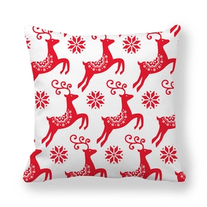 Detail of red Christmas reindeer and snowflake pattern on peach skin pillowcase