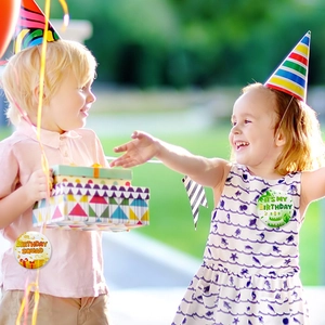 Detail of children wearing Birthday Squad and It's My Birthday tinplate party badges