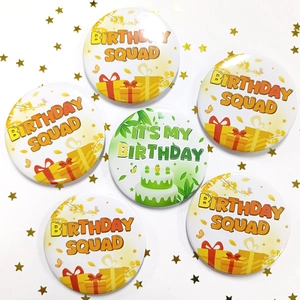 Macro view of six round tinplate birthday badges with safety pin on white background