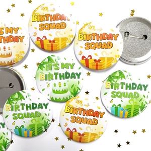 Close-up of tinplate birthday party badges with Birthday Squad text and safety pins