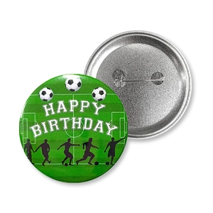 Macro shot of football themed tin badge showing front graphic and back safety pin detail