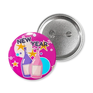 Front and back detail of New Year tinplate badge with pin fastener and pink graphics