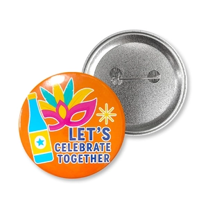 Macro view showing both front festive design and metal safety pin back of the tin badge