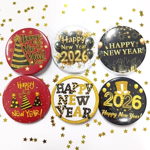 Close-up of 6-piece Happy New Year 2026 tinplate badges with gold glitter party designs