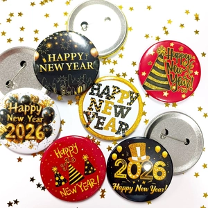 Detail of 2026 Happy New Year tinplate badges with gold fireworks and city silhouettes