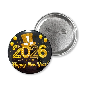 Detail of 2026 Happy New Year tinplate badge showing front design and pin back closure