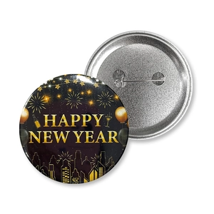 Macro detail of Happy New Year tinplate badge showing both front design and back pin