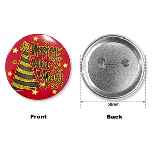 Front and back detail of 58mm Happy New Year tinplate badge with gold art font and safety pin
