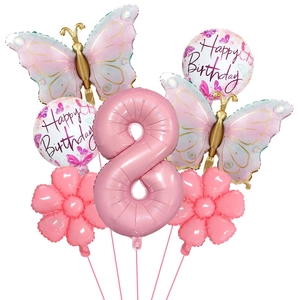 Detail of pink number 8 butterfly balloon set with floral accents for birthday party