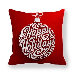 Detail of red pillowcase with white Happy Holidays text in a Christmas ornament design