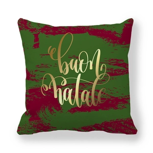Détail de l'inscription Buon Natale dorée sur housse de coussin rouge et verte