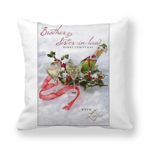 Detail of Christmas peach skin cushion cover featuring champagne and festive greenery graphics