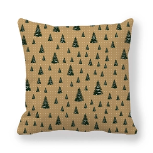 Detail of peach skin fabric pillowcase with dark green Christmas tree pattern and snowflakes