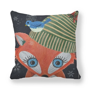 Detail of fox illustration pillowcase with knit hat and snowy dark background