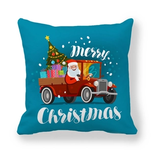Detail of Christmas pillow cover with Santa driving a red gift truck on navy blue fabric