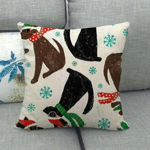 Linen Christmas pillow case with festive dog prints on a cozy grey sofa setting