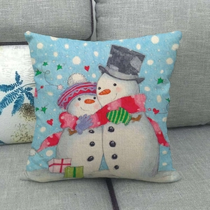 Linen Christmas snowman pillowcase shown on a gray sofa for winter home decor
